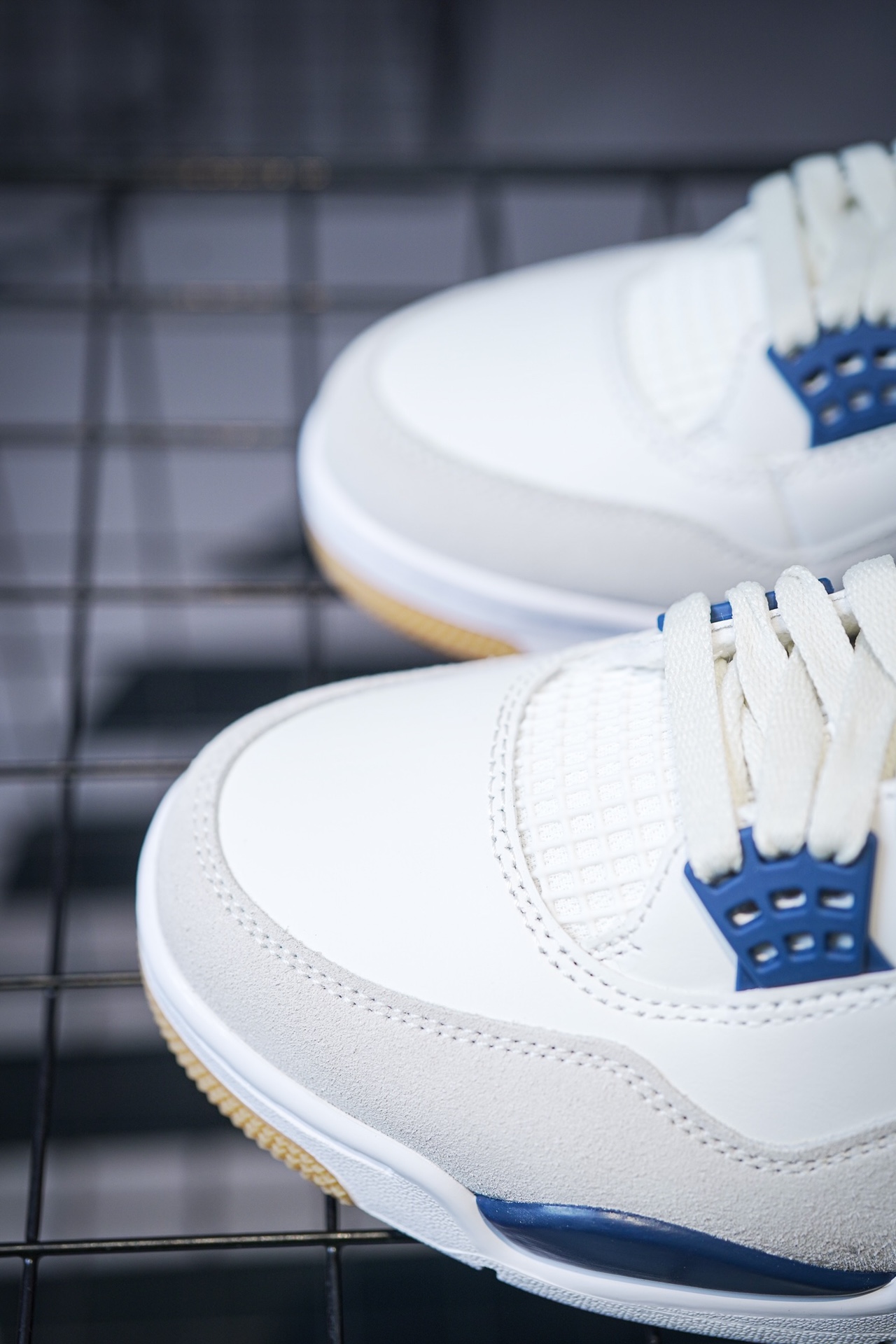 NK SB x Air Jordan 4 'Navy' collaboration in white and blue.
