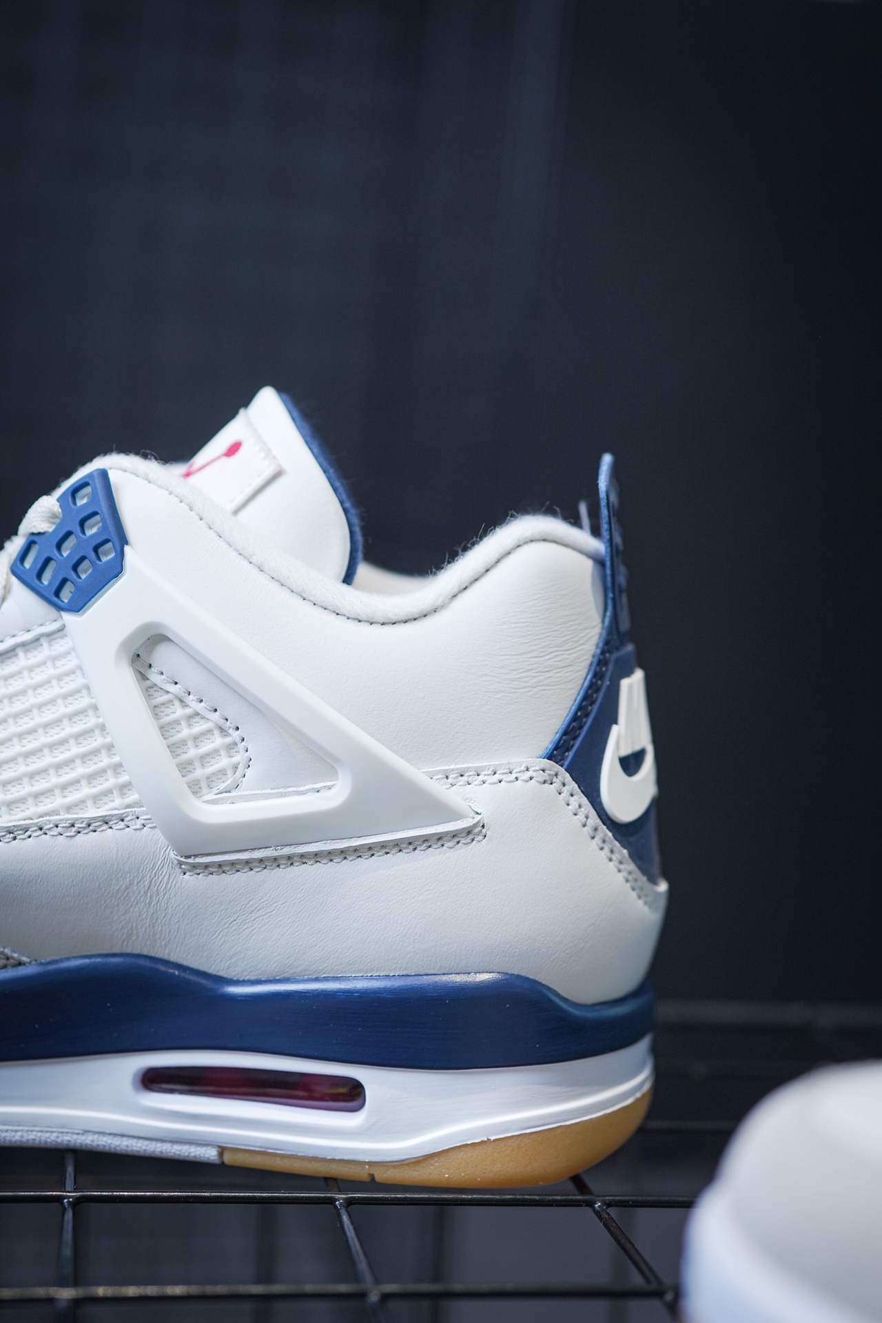 NK SB x Air Jordan 4 'Navy' collaboration in white and blue.