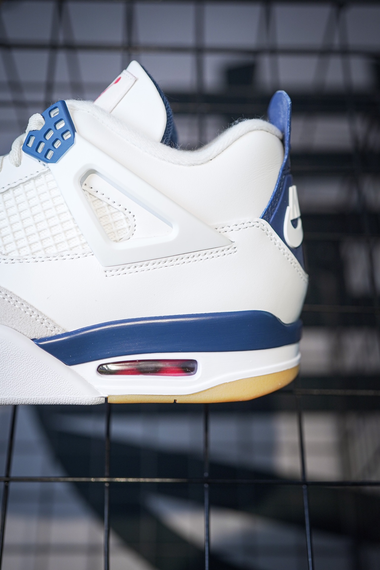 NK SB x Air Jordan 4 'Navy' collaboration in white and blue.