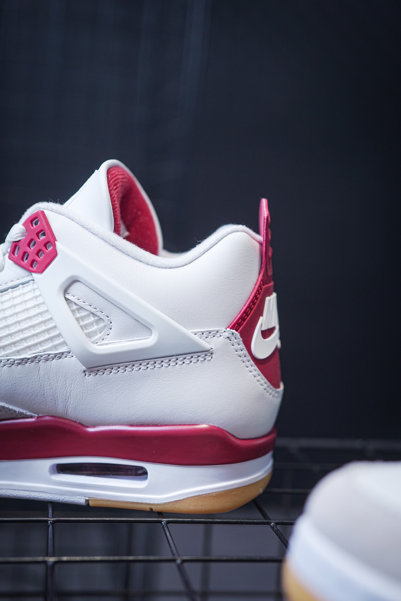 NK SB x Air Jordan 4 collaboration in white and red, military green, gray and brown, and red brick.